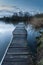 Calm tranquil moonlit landscape over lake and jetty