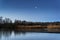 Calm tranquil moonlit landscape over lake and jetty