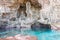 Calm turquoise colored water in pool in limestone cave on coast