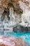 Calm turquoise colored water in pool in limestone cave on coast