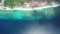 Calm turquoise transparent ocean water and narrow sand beach