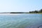 Calm Ware Beach with Clean Blue Water, Trees and an Island