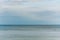 Calm water surface on which orange buoys fly