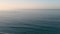 Calm Waves In The Ocean During Sunrise . aerial static