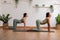 Calm of wellness Couple Asian young woman sit on yoga mat doing breathing exercise yoga cat cow pose together.Yoga meditation of