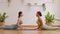 Calm of wellness Couple Asian young woman sit on yoga mat doing breathing exercise yoga cobra pose together.Yoga meditation of two
