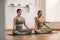 Calm of wellness Couple Asian young woman sit on yoga mat doing breathing exercise yoga lotus pose together.Yoga meditation of two