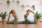 Calm of wellness Couple Asian young woman sit on yoga mat doing breathing exercise yoga  One Legged King Pigeon pose together.Yoga
