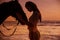 Calm woman cuddling a majestic stallion