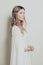 Calm woman elf in white dress. Mysterious elven sorceress princess halloween character costume