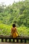 Calm young woman looking forward at forest