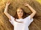 Calm Young woman is relaxing   on the haystack