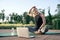 Calm your mind. Athletic beautiful middle aged woman watching instructional videos on a laptop while exercising on a mat