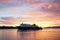 A Calmac ferry entering Oban harbour in the Scottish highlands during sunset