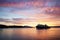 A Calmac ferry entering Oban harbour in the Scottish highlands during sunset