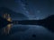 A calming scene by a quiet lakeside, where the reflection of shimmering stars on the water\\\'s surface