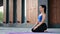 Calmness yoga woman sitting on mat outdoor breathing relaxing harmony life balance modern building