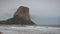 Calpe seashore and Penon de Ifach, Spain. Low clouds rolling over mountain