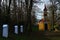 Calvary with small chapel from 1925 nd white Stations of the Cross hidden in circle of naked broadleaf trees, winter season