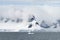 Calving glacier and clouds covering the coastline of Paradise Ba