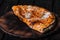 Calzone - Stuffed Pizza with Tomato, Mozzarella and Ham on wood
