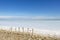 Camargue white salt flat lake, etang salt water lagoon surrounded by sand dunes, Southern France