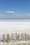 Camargue white salt flat lake, etang salt water lagoon surrounded by sand dunes, Southern France