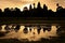 Cambodia, Siem Reap, Angkor Wat Temple silhouette with sunset sky