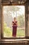 Cambodian Asian Girl in Traditional Dress in a Stone Doorway at Angkor Temple