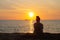 Cambodian Asian Woman Watching the Sunset & Boat by the Ocean