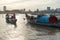 Cambodian city skyline and working,residential river boats at sunset