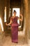 Cambodian Girl in Dancing in Khmer Dress in Hallway of Ancient Building of Angkor City