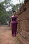 Cambodian Girl in Khmer Dress by the Ancient Wall of Phnom Bakheng, Angkor City