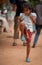 Cambodian girl plays JiÃ nzi at market Angkor Wat