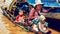 Cambodian people live on Tonle Sap Lake in Siem Reap, Cambodia. Mother with the children in the boat