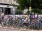 Cambridge, UK - October 9, 2019: Bicycles parked against the fence with a lot of posters