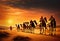 Camel caravan in the Sahara desert at sunset, Morocco, Africa