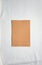 Camel colored empty paper sheet on white linen