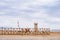 Camel, wooden fences and watchtower at the historical site of Yang Pass, in Yangguan, Gansu, China