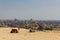 Cameleer and camel and city view at giza pyramid , cairo in egy