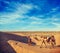 Cameleer (camel driver) with camels in dunes of Thar desert. Raj