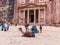 Camels are lying on the ground and are resting and waiting for tourists in the square in front of Al-Khazneh in Petra near Wadi Mu