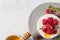 Camembert cheese with fresh berries, honey and thyme on white background. Healthy snack. French appetizer. Top view