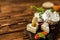 Camembert cheese on a rustic background. Noble cheese with mold. An overhead view of cheese with noble white mold and walnuts on a