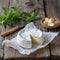 Camembert cheese on rustic wooden table