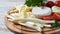 Camembert with String cheese or cheese whip - salty snack cheese with cherry tomatoes and herbs