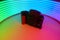 a camera against a background of neon rays
