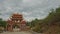 Camera Approaches Buddhist Temple Gates against Cloudy Sky