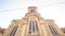 Camera Approaches Front Wall at Backlight of Catholic Church