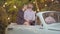 Camera approaches to relaxed loving couple sitting in retro car and chatting. Portrrait of happy Caucasian man and woman